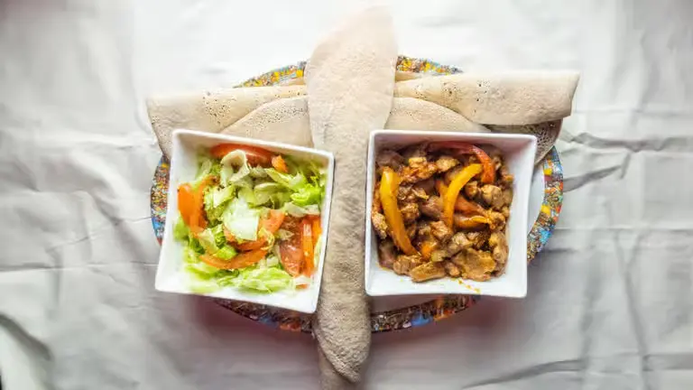 Yebeg Tibs – tender marinated lamb with peppers, onions, tomatoes, and spices at Merkato Restaurant Winnipeg