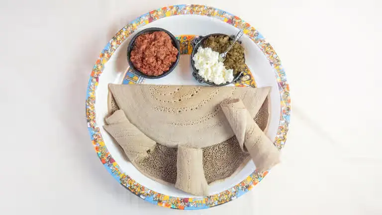 Kitfo Ethiopian seasoned minced beef with kibbeh and mitmita spice at Merkato Restaurant Winnipeg