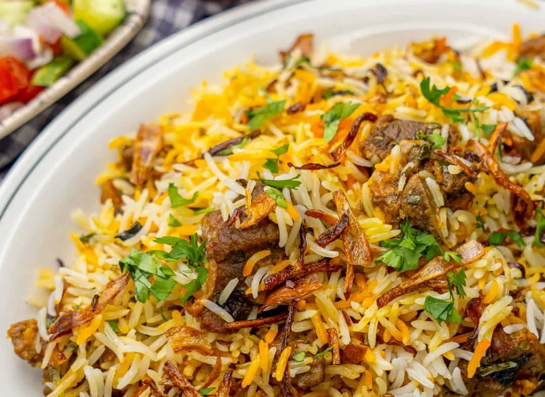 Yebeg Tibs tender marinated lamb with peppers onions tomatoes and spices at Merkato Restaurant Winnipeg